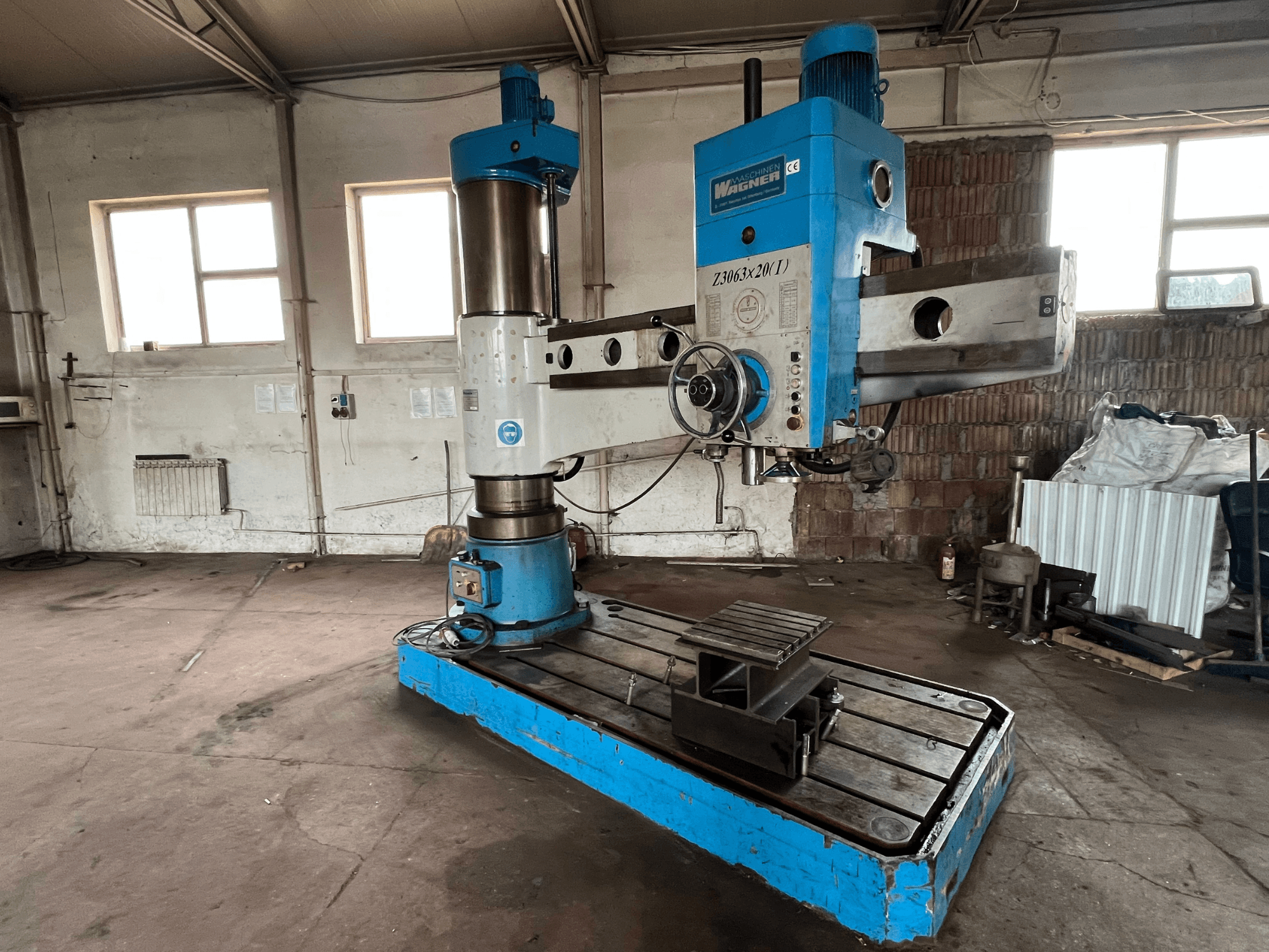 Wagner Z3063x210 drilling machine in a workshop, front view; features a blue and silver design with a metal base and work table.