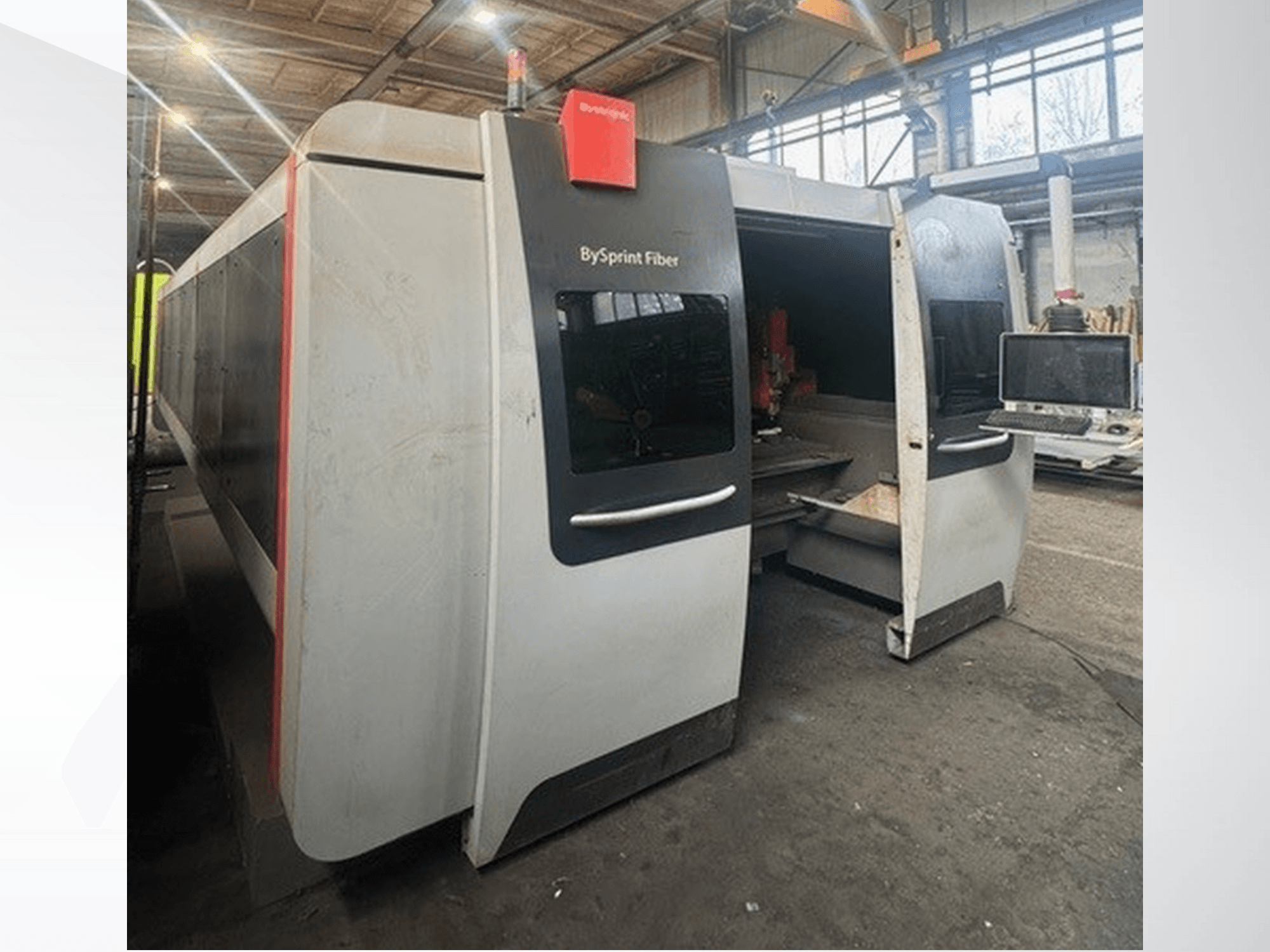 BySprint Fiber machine from Brünswick, front view showing dual openings, touchscreen control panel, and industrial workspace inside.