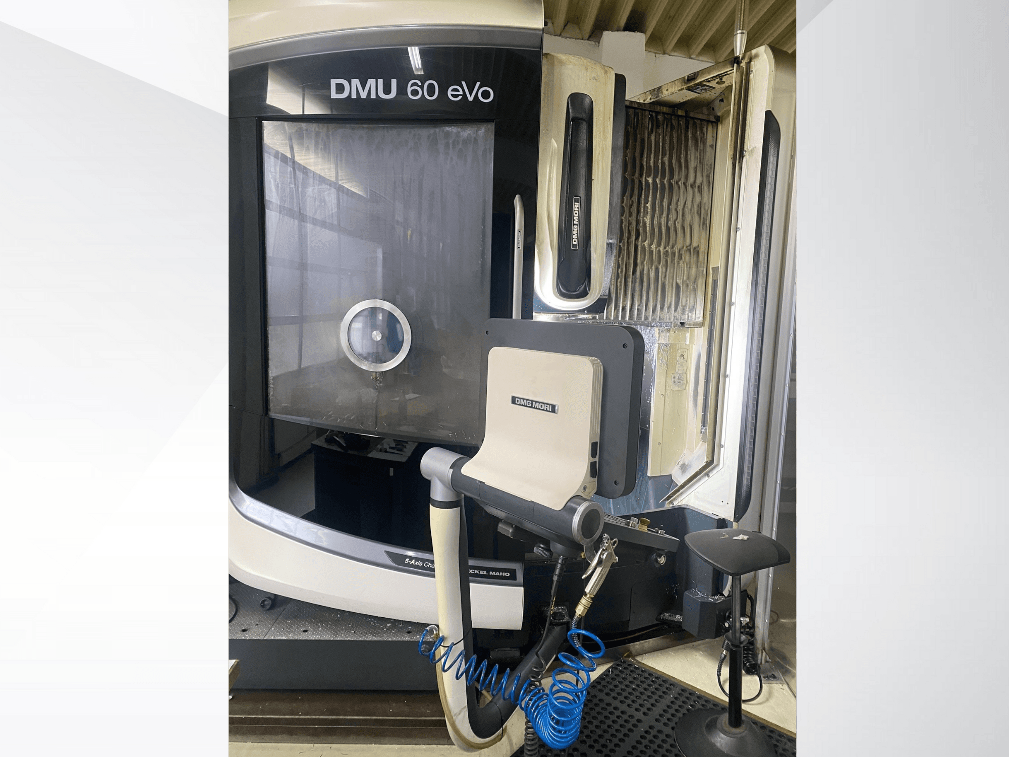 DMU 60 eVo CNC milling machine, front view, showing control panel and tools, ideal for precision machining.