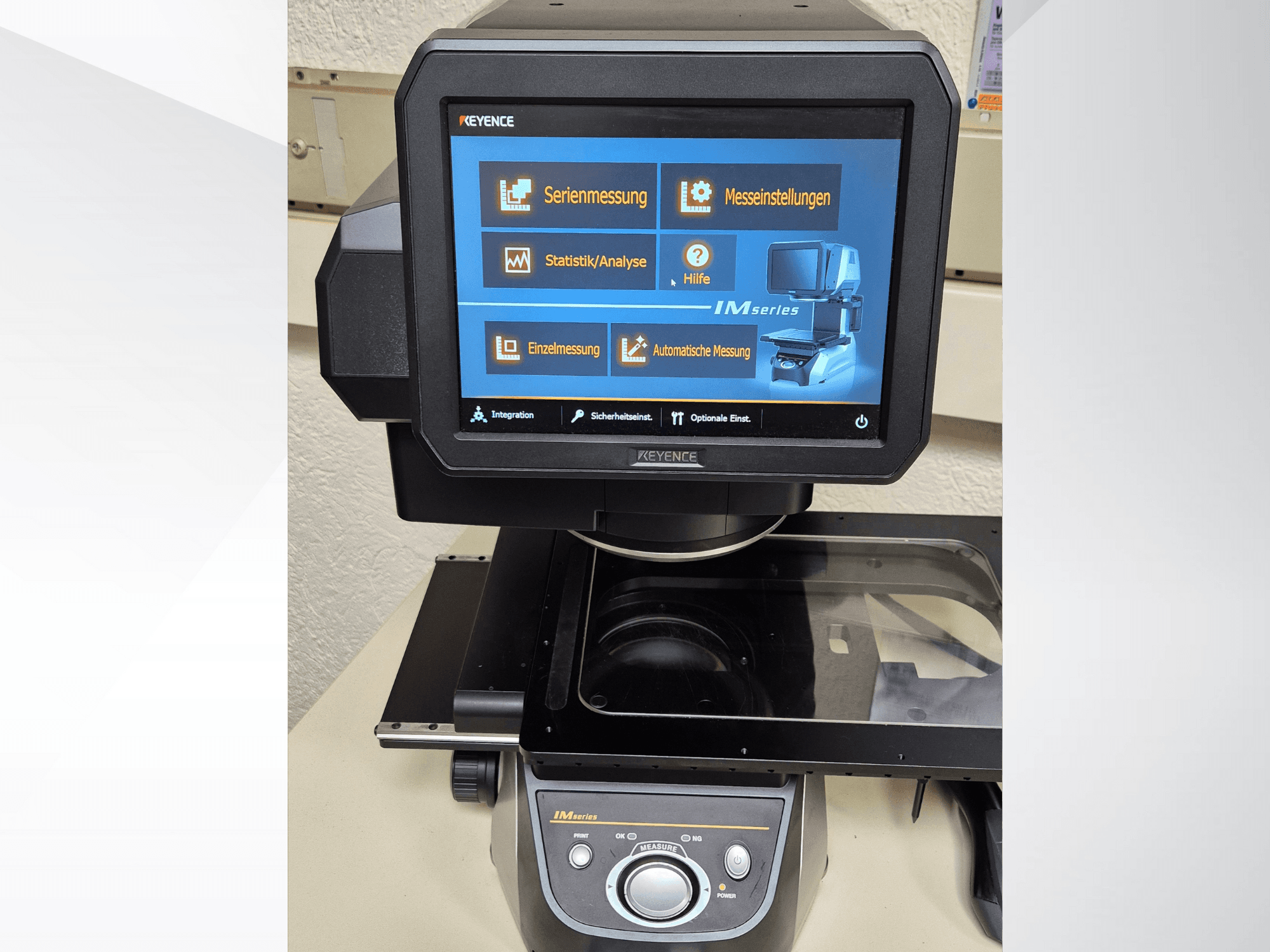KEYENCE IM series measurement device front view with touchscreen display showcasing measurement options and controls.