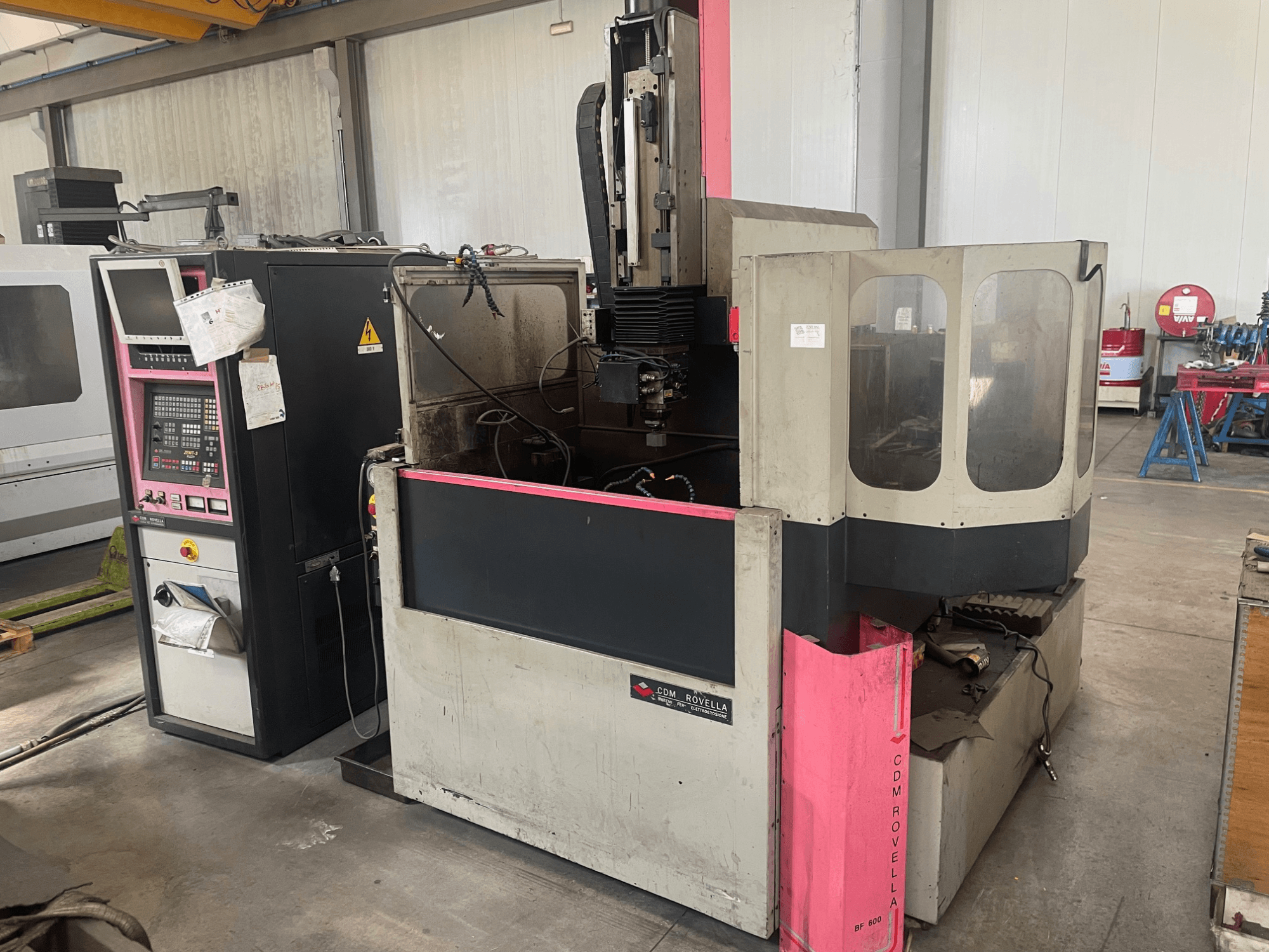 CDM Rovella BF 800 machining center, side view showing control panel, dust cover, and industrial setting.