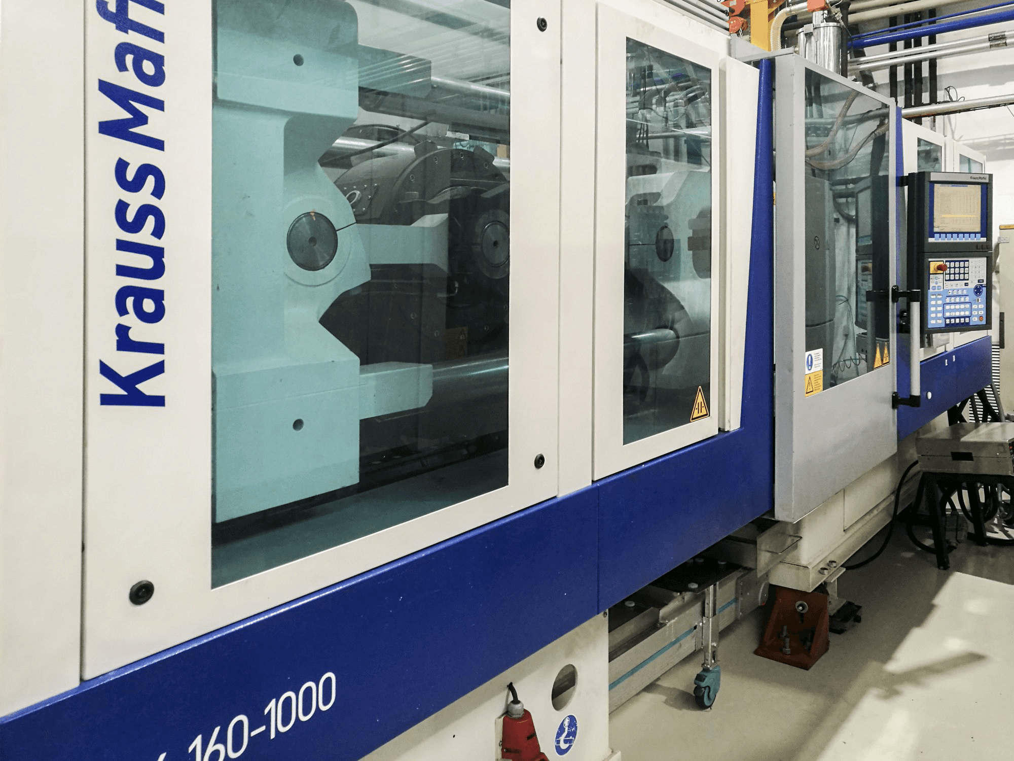 Left view of Krauss Maffei 160-1000 EX Machine